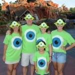 Disney Parks All-Nighter guests, otherwise known as NDM 130 & her family, show off their custom Mike Wazowski shirts May 24, 2013 as the sun rises over Splash Mountain at Magic Kingdom in Lake Buena Vista, Fla. (Todd Anderson, photographer)